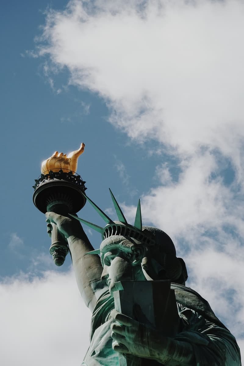 Statue of Liberty in New York City under blue and white skies