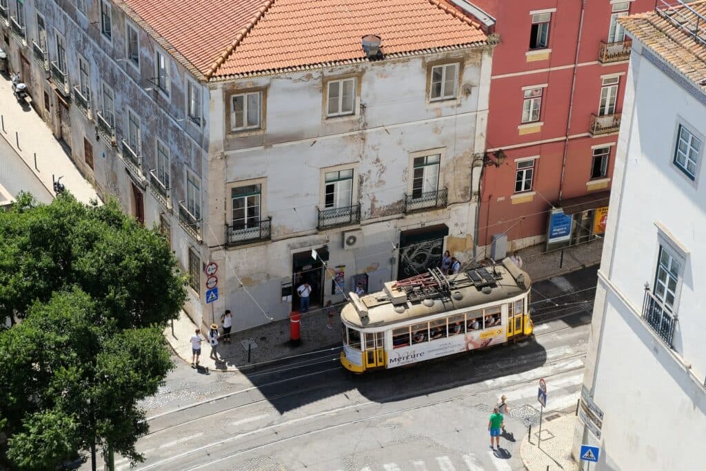 white and black bus on road near building during daytime