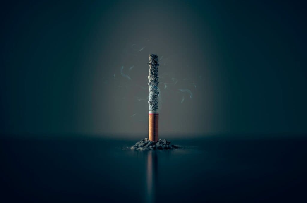 single cigarette stick with ashes stick