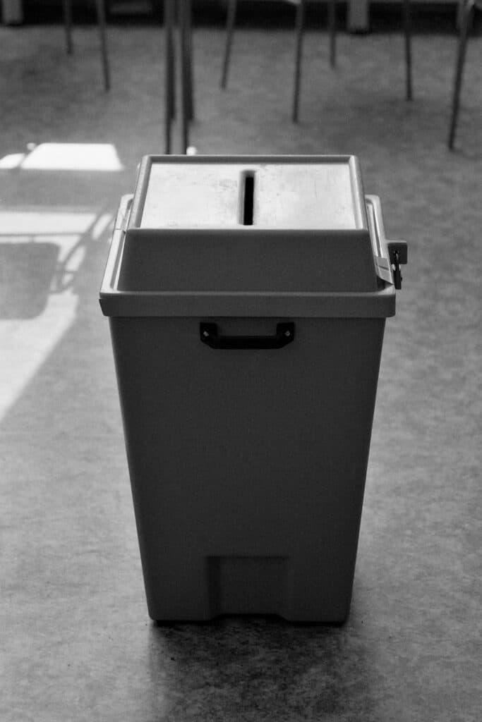 a black and white photo of a trash can