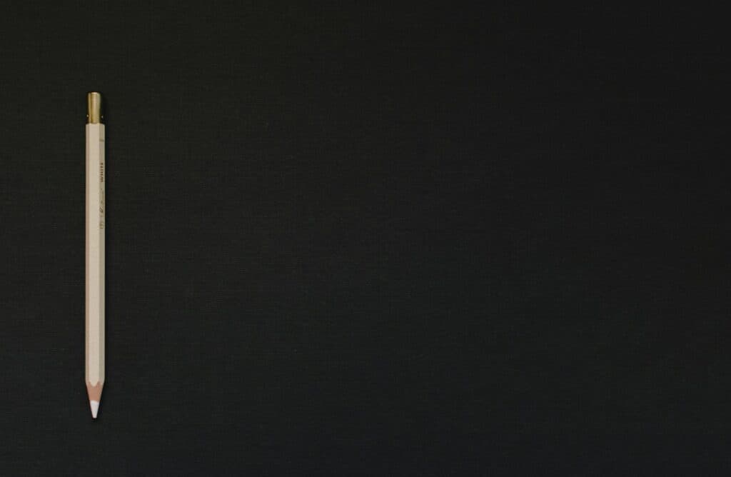 white pencil on black platform