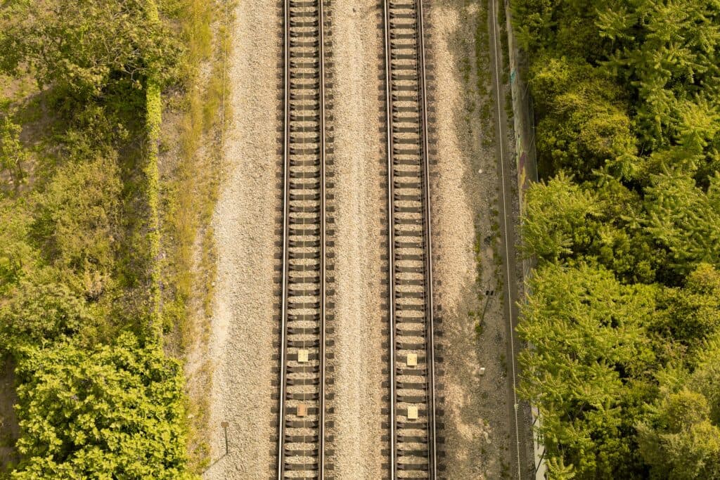 aerial photography of train tracks near forest
