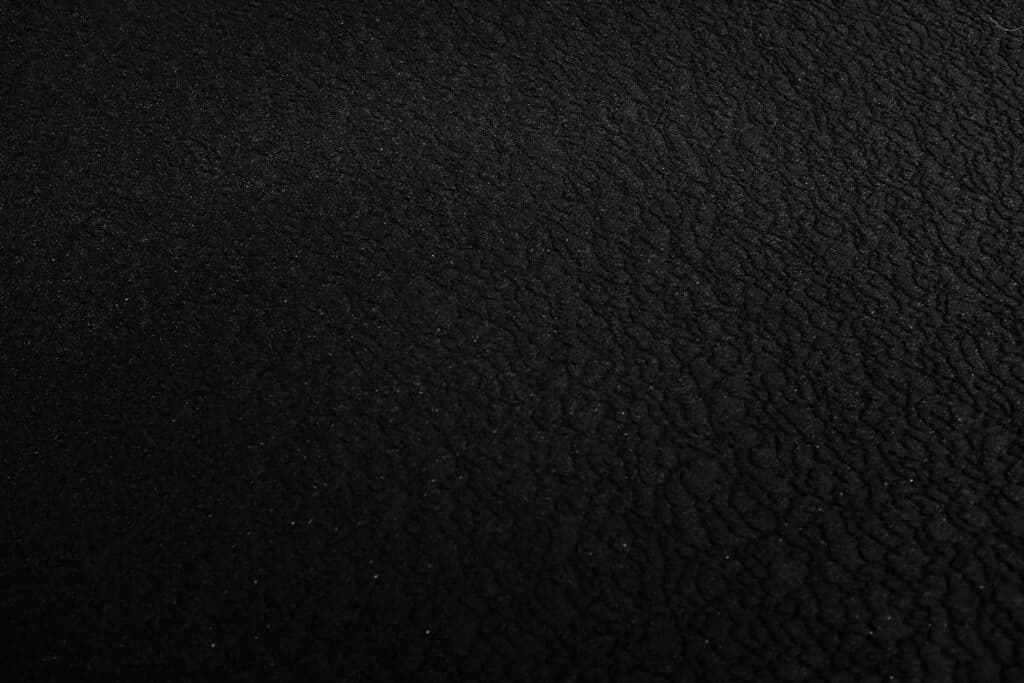 a black and white photo of a black surface