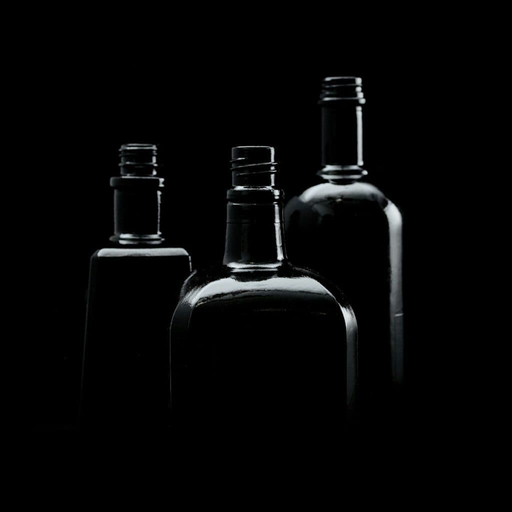 three empty bottles are shown in black and white