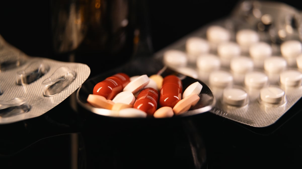 A plate of pills and a contraption on a table